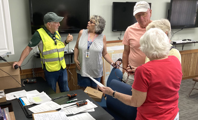 Observers from other communities review communications in the Hurricane Yankee drill April 23, 2024.