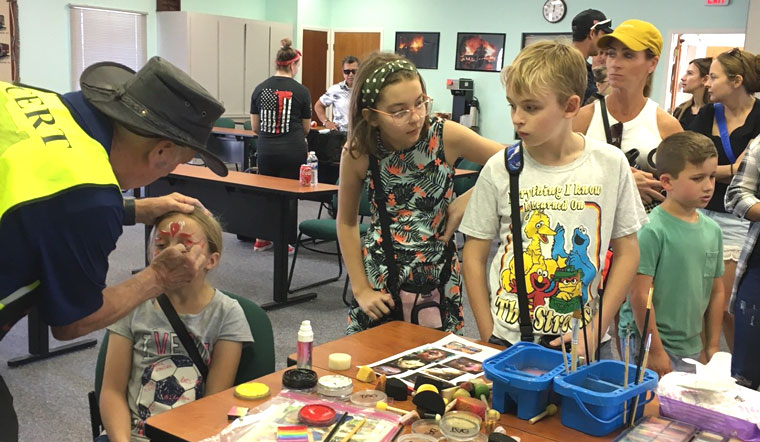 Trailer Estates CERT member Dan Smith applies face paint